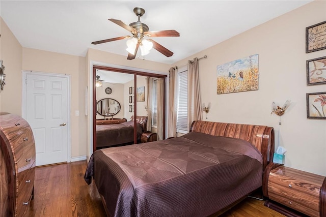 bedroom featuring ceiling fan, a closet, and dark hardwood / wood-style floors