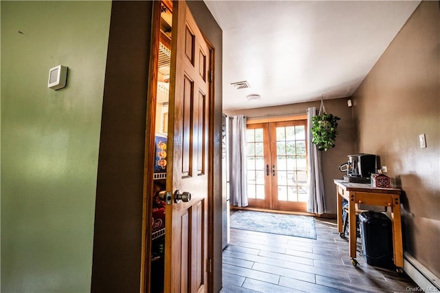 doorway with french doors, dark hardwood / wood-style floors, and baseboard heating