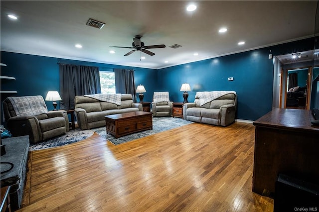 living room with ceiling fan, wood-type flooring, and ornamental molding