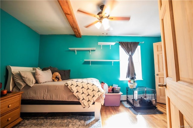 bedroom featuring ceiling fan, beam ceiling, and wood-type flooring