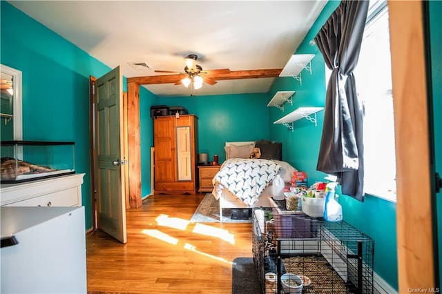 bedroom with ceiling fan and hardwood / wood-style flooring