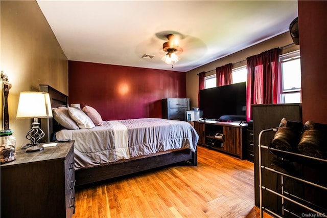 bedroom with light hardwood / wood-style flooring and ceiling fan