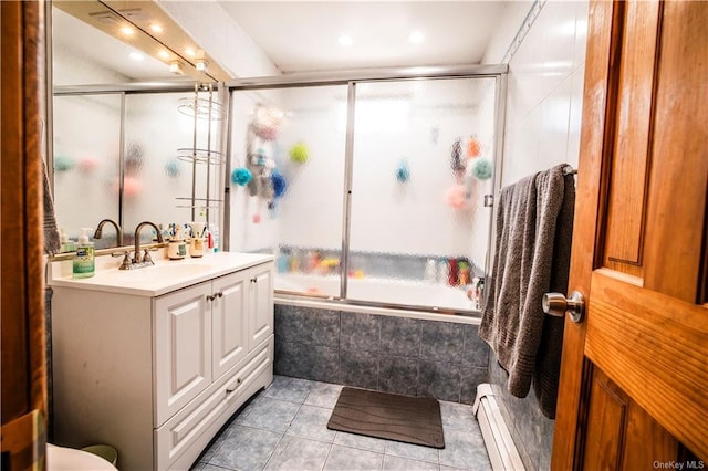 bathroom with tile patterned flooring, vanity, enclosed tub / shower combo, and a baseboard radiator