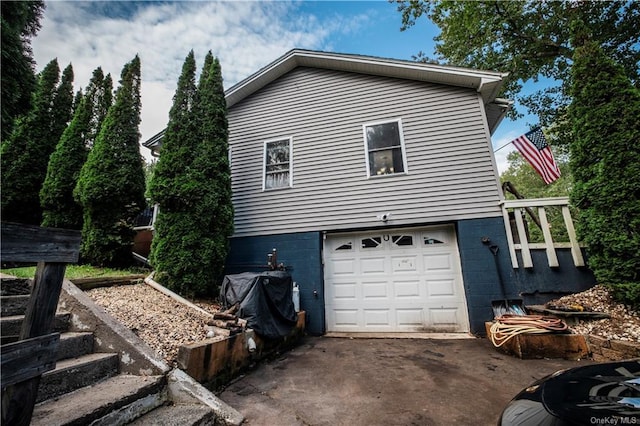 view of side of home featuring a garage