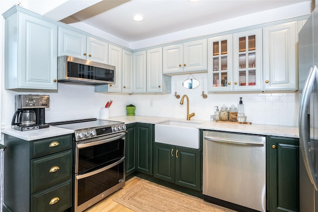 kitchen featuring sink, white cabinets, and appliances with stainless steel finishes