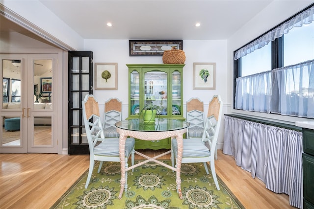 dining space featuring french doors and light wood-type flooring