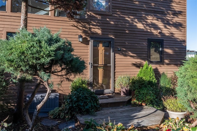 view of exterior entry featuring a deck