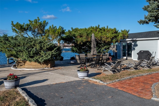 exterior space featuring a patio and a water view