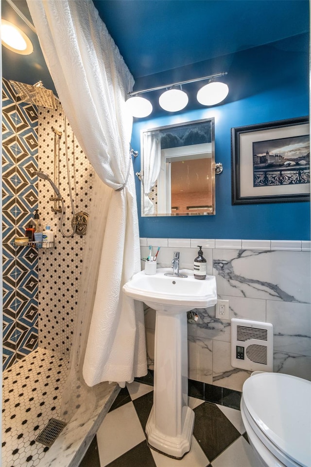 bathroom featuring toilet and tile walls