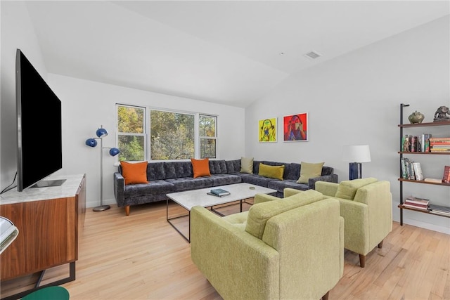 living room with light hardwood / wood-style flooring and lofted ceiling