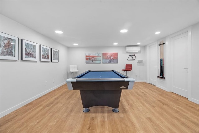 playroom featuring a wall mounted air conditioner, billiards, and light hardwood / wood-style flooring