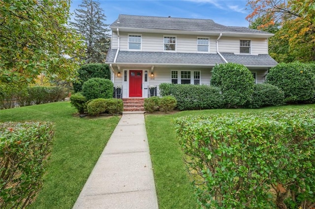 view of property featuring a front lawn