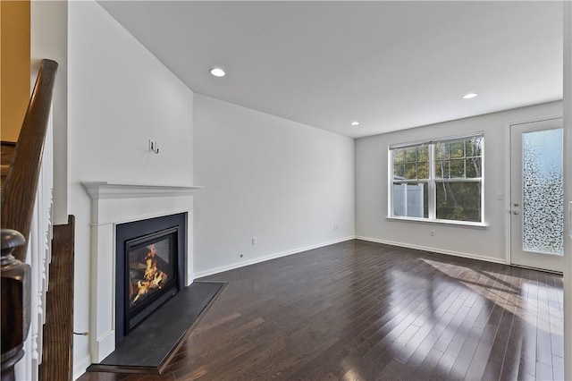 unfurnished living room featuring dark hardwood / wood-style flooring