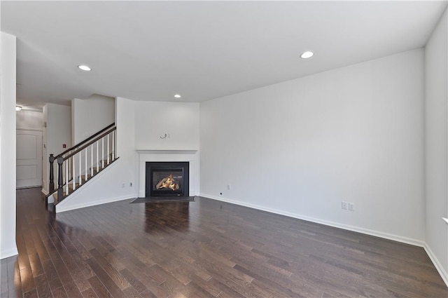 unfurnished living room with dark hardwood / wood-style floors