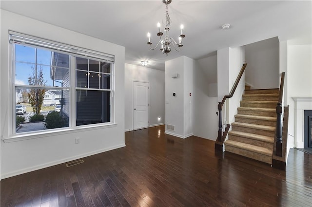 interior space with dark hardwood / wood-style floors and an inviting chandelier