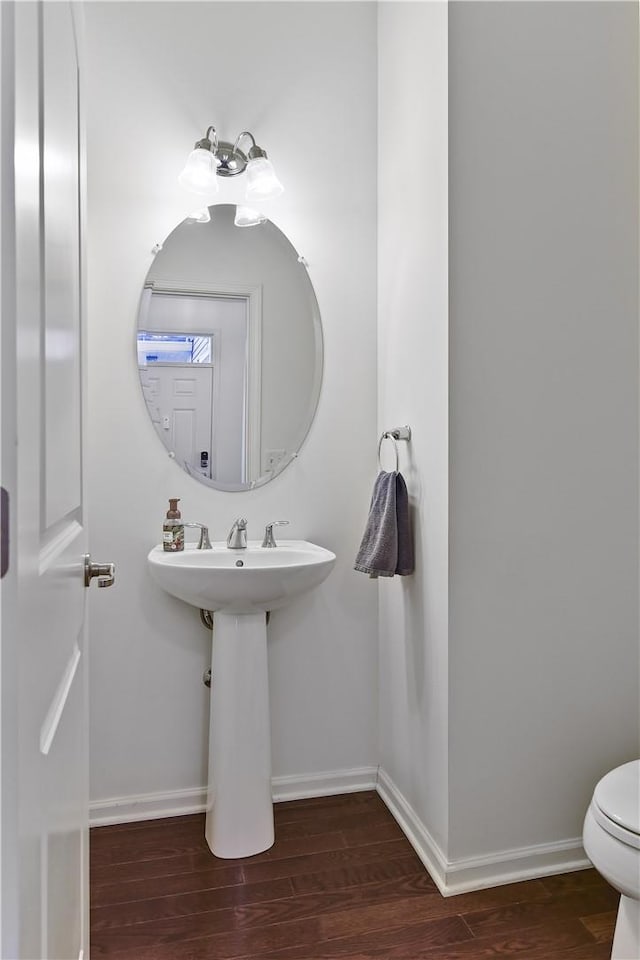 bathroom with wood-type flooring and toilet