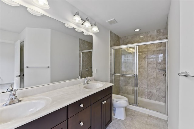 bathroom featuring tile patterned floors, toilet, vanity, and walk in shower