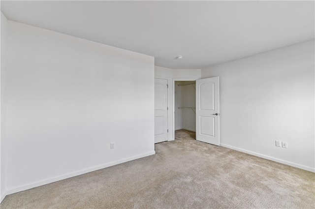 unfurnished bedroom featuring light carpet