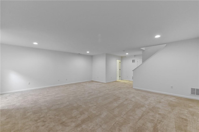 basement featuring light colored carpet