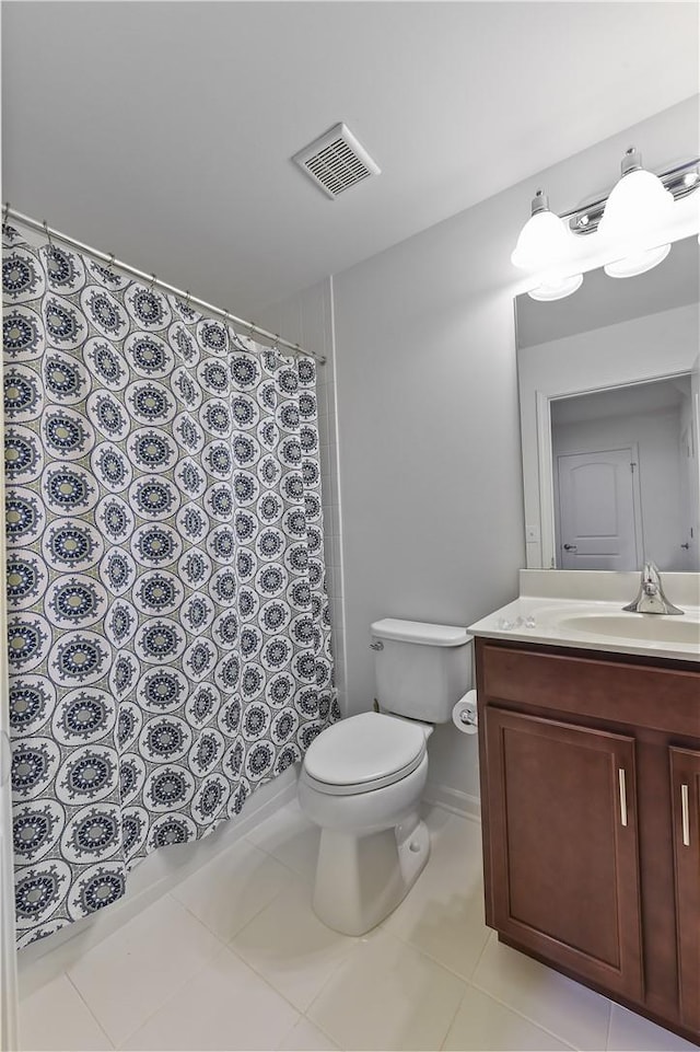 bathroom featuring tile patterned flooring, vanity, and toilet