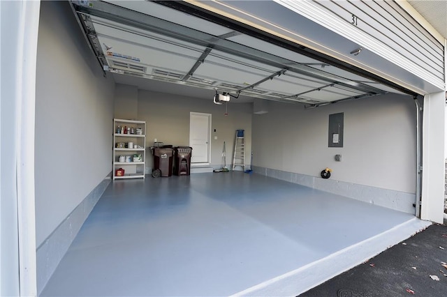 garage with a garage door opener and electric panel