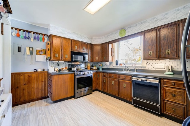 kitchen featuring backsplash, sink, and black appliances