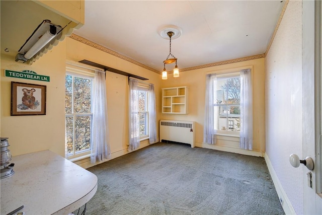 dining room with carpet flooring, radiator, and ornamental molding