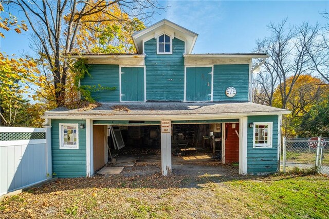 rear view of property with a garage