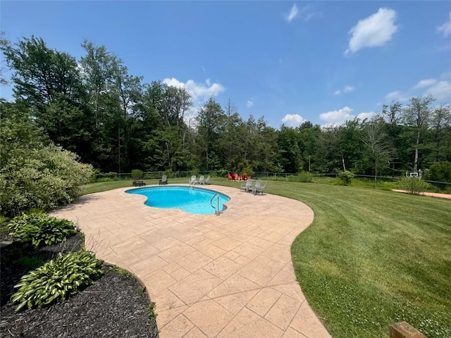 view of swimming pool featuring a patio and a lawn