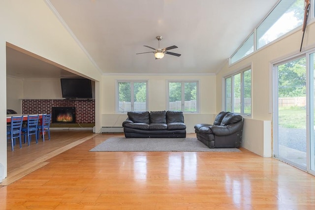 4 Newport Dr, Nanuet, NY 10954 - living room with baseboard heating, healthy amount of natural light, wood finished floors, ornamental molding, and high vaulted ceiling