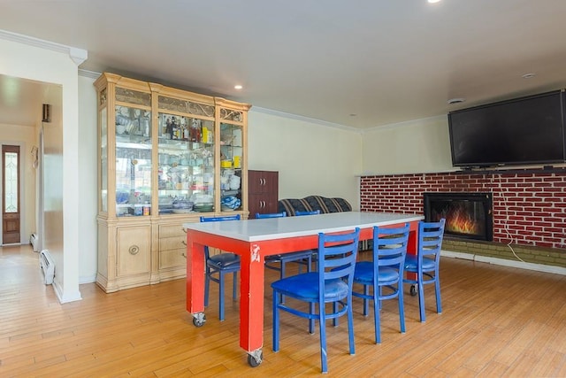 4 Newport Dr, Nanuet, NY 10954 - dining room featuring crown molding, a fireplace, a baseboard heating unit, light wood-style floors, and recessed lighting
