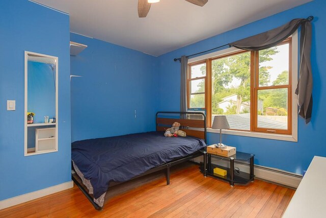 4 Newport Dr, Nanuet, NY 10954 - bedroom with hardwood / wood-style flooring, a baseboard heating unit, ceiling fan, and baseboards