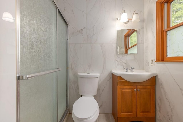4 Newport Dr, Nanuet, NY 10954 - bathroom featuring vanity, a stall shower, toilet, and tile walls
