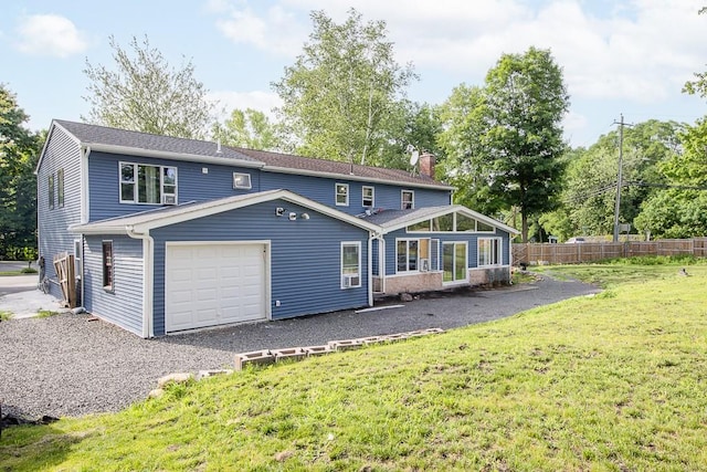 4 Newport Dr, Nanuet, NY 10954 - rear view of house with a chimney, a garage, and gravel driveway
