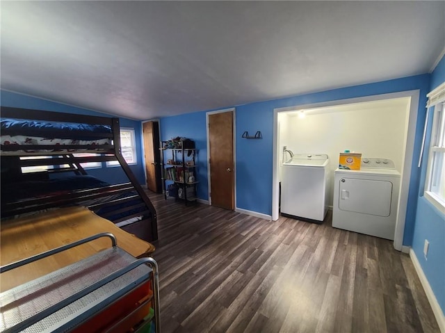 bedroom with lofted ceiling, dark wood-type flooring, and washing machine and clothes dryer