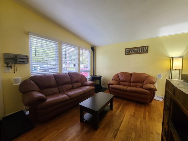 living room featuring hardwood / wood-style flooring and vaulted ceiling