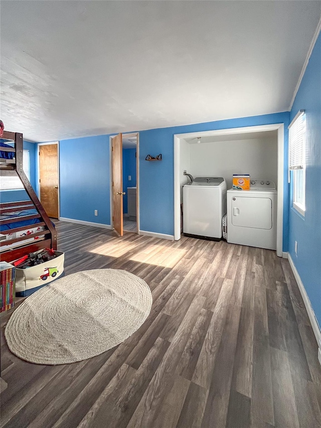 interior space with hardwood / wood-style floors and washing machine and clothes dryer