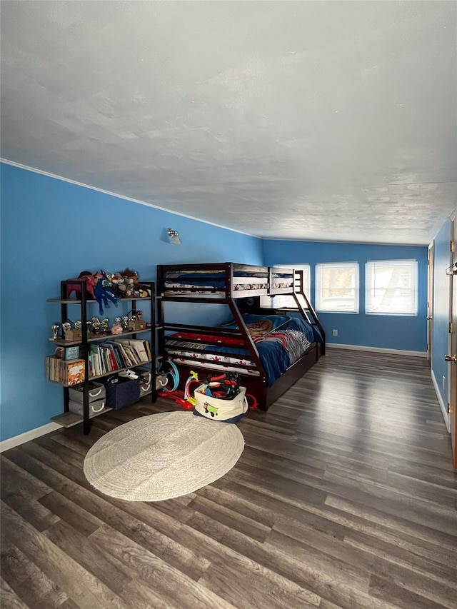 bedroom with dark hardwood / wood-style flooring