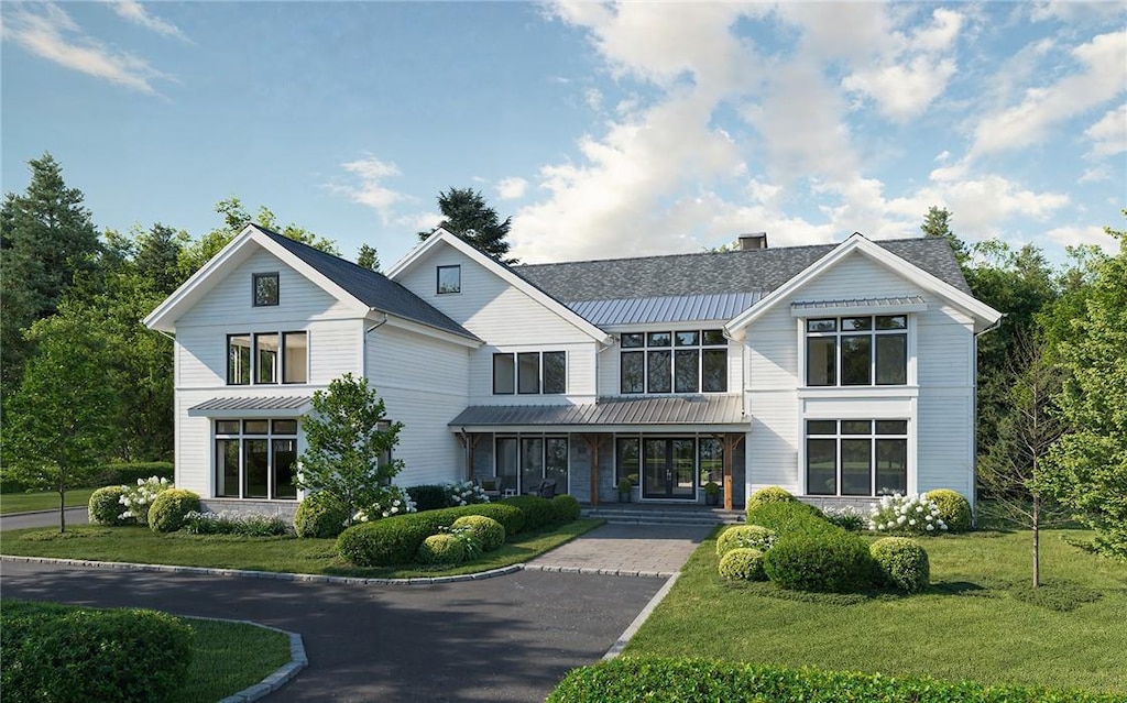 16 Stone Bridge Rd, Purchase, NY 10577 - view of front of property with covered porch and a front yard