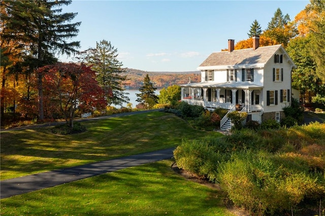 view of front of property with a porch and a front yard