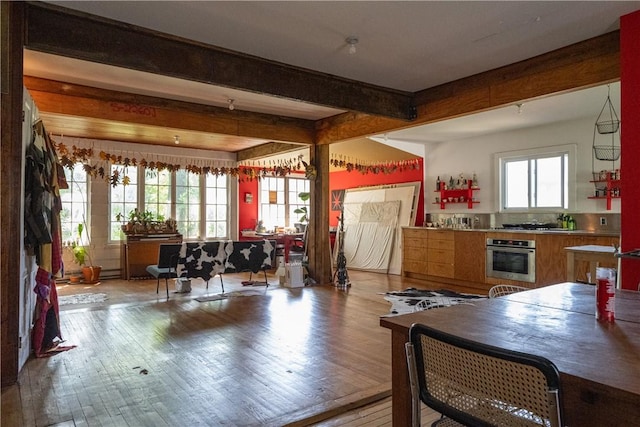 kitchen with hardwood / wood-style floors, oven, and beamed ceiling