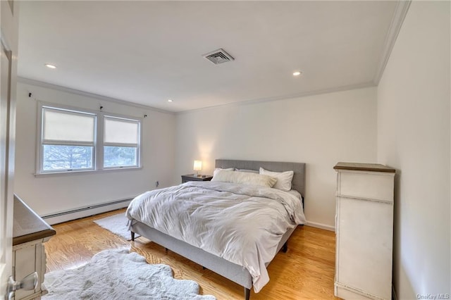 bedroom featuring light wood-type flooring, baseboard heating, and ornamental molding