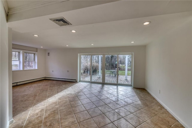 empty room featuring light tile patterned flooring and a healthy amount of sunlight