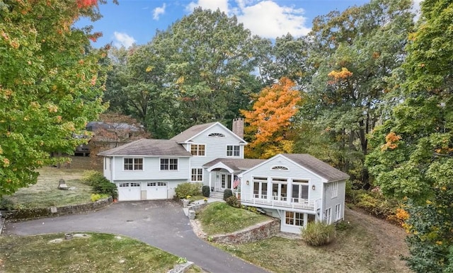 view of front of home with a front yard and a garage