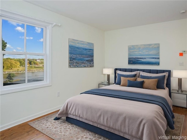 bedroom with hardwood / wood-style floors