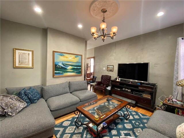 living room with wood-type flooring and a notable chandelier