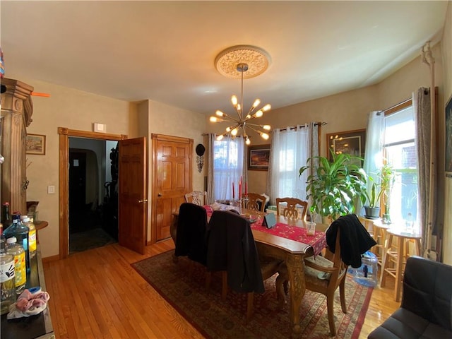 dining room featuring light hardwood / wood-style floors and an inviting chandelier