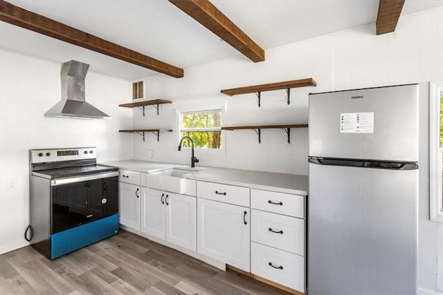 kitchen with white cabinetry, sink, wall chimney exhaust hood, appliances with stainless steel finishes, and light wood-type flooring