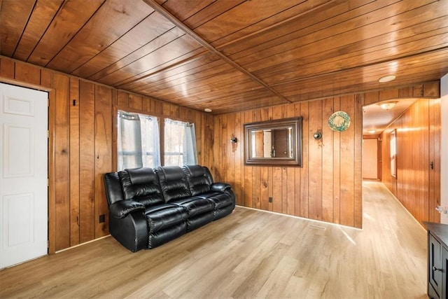 living room featuring light hardwood / wood-style floors, wooden walls, and wood ceiling