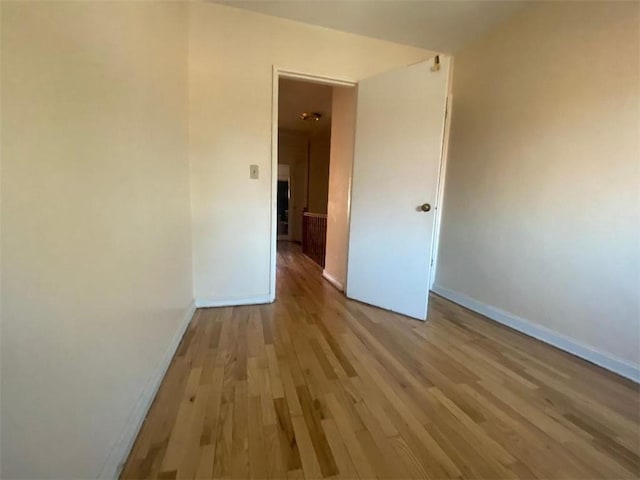 spare room with light hardwood / wood-style flooring